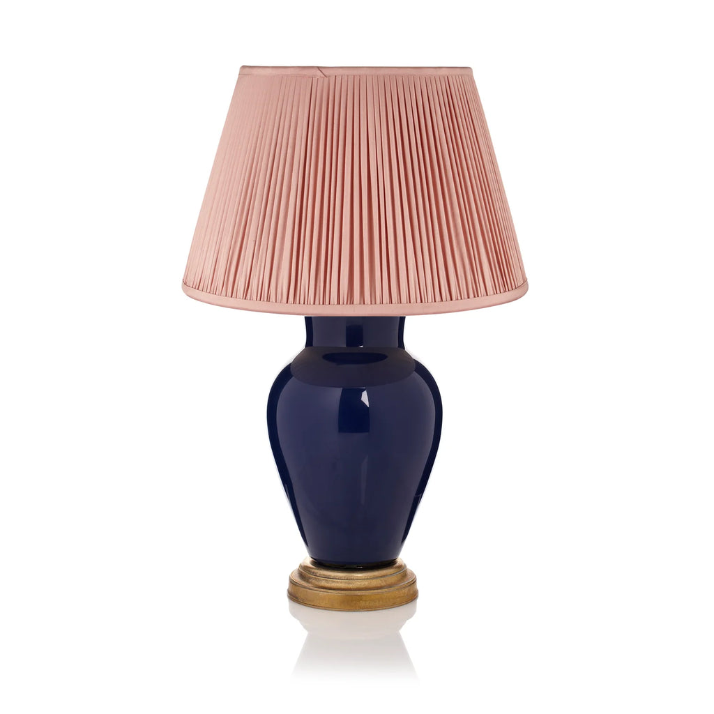Rosanna Lonsdale Dusty Pink Pleated Silk empire lampshade styled on a deep blue ceramic table lamp with brass base