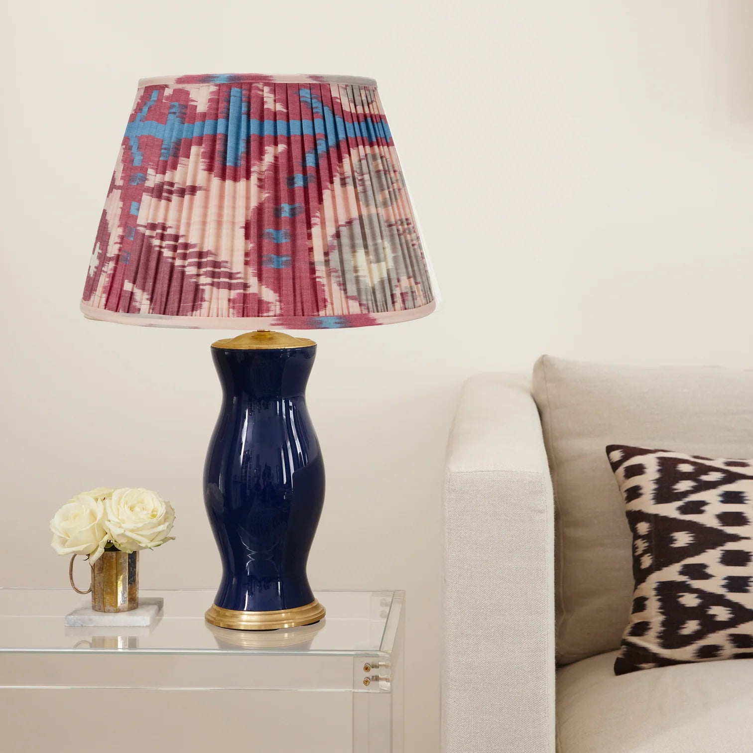 Rosanna Lonsdale Pink and Fuchsia Ikat Lampshade styled on a navy blue ceramic table lamp in Nashville, Tennessee