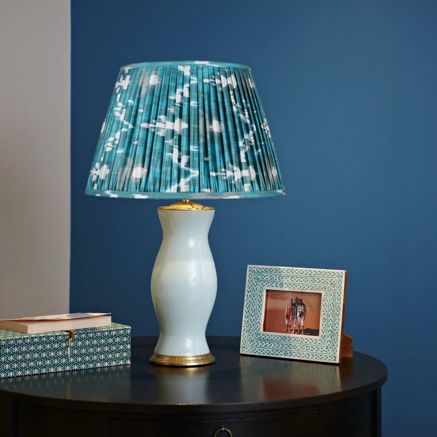 Verdigris and Jade Green Silk Ikat Lampshade styled on a white ceramic table lamp in Nashville, Tennessee