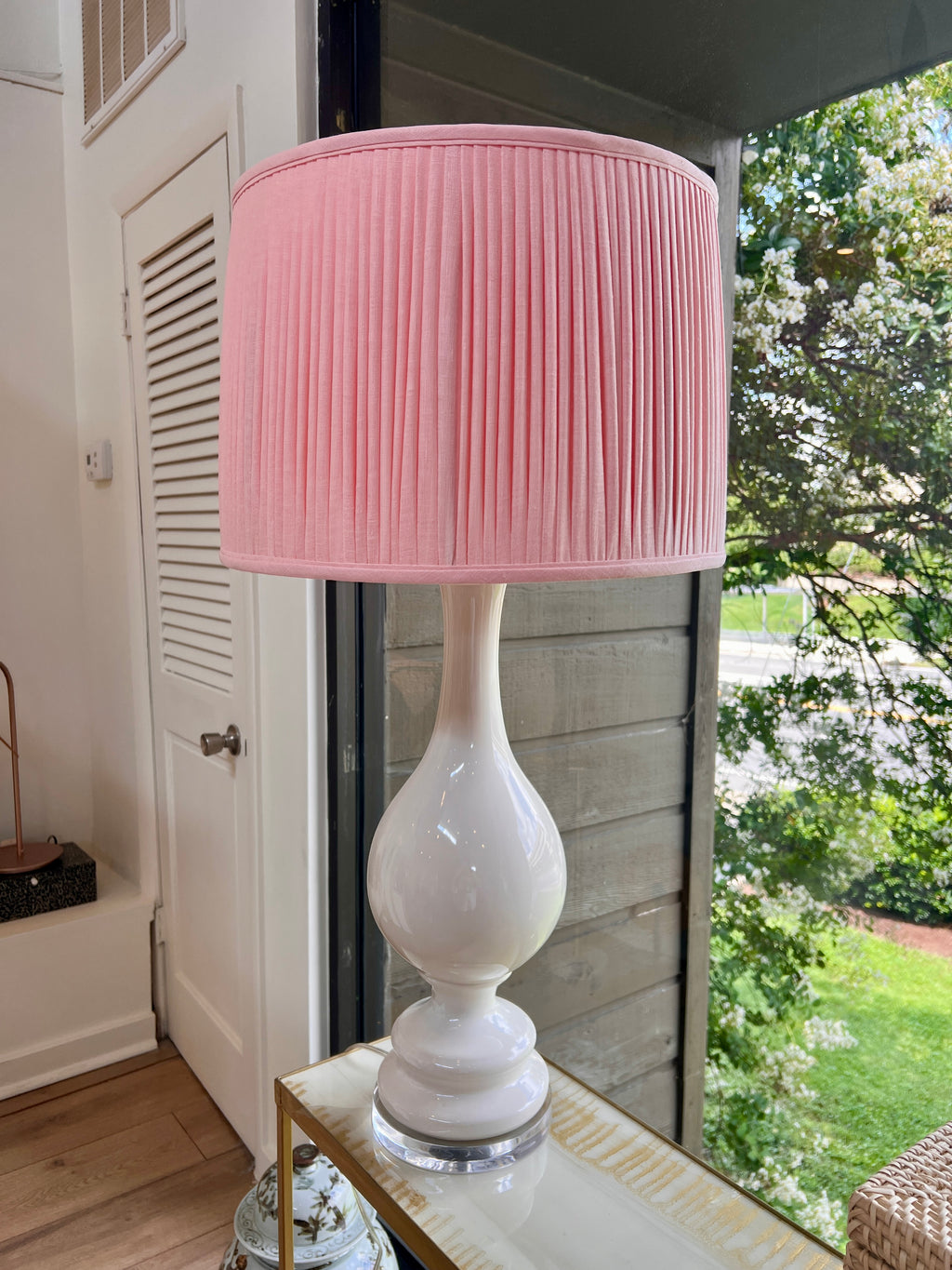 Sorella Glen Light Pink Shirred Drum Lampshade styled on a large white ceramic table lamp in Nashville, Tennessee