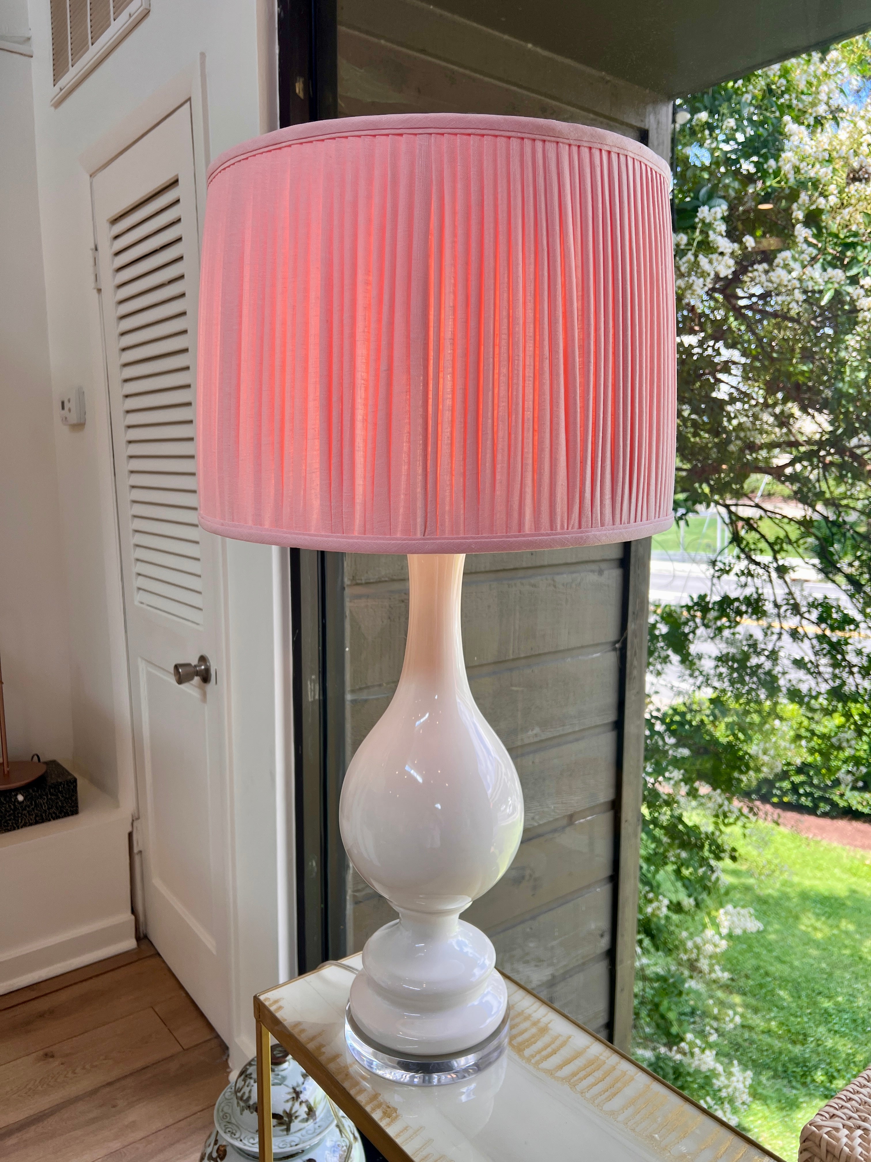Sorella Glen Light Pink Shirred Drum Lampshade styled on a large white ceramic table lamp in Nashville, Tennessee