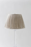Sorella Glen Oatmeal Shirred Empire Lampshade styled on an acrylic table lamp in Nashville, Tennessee