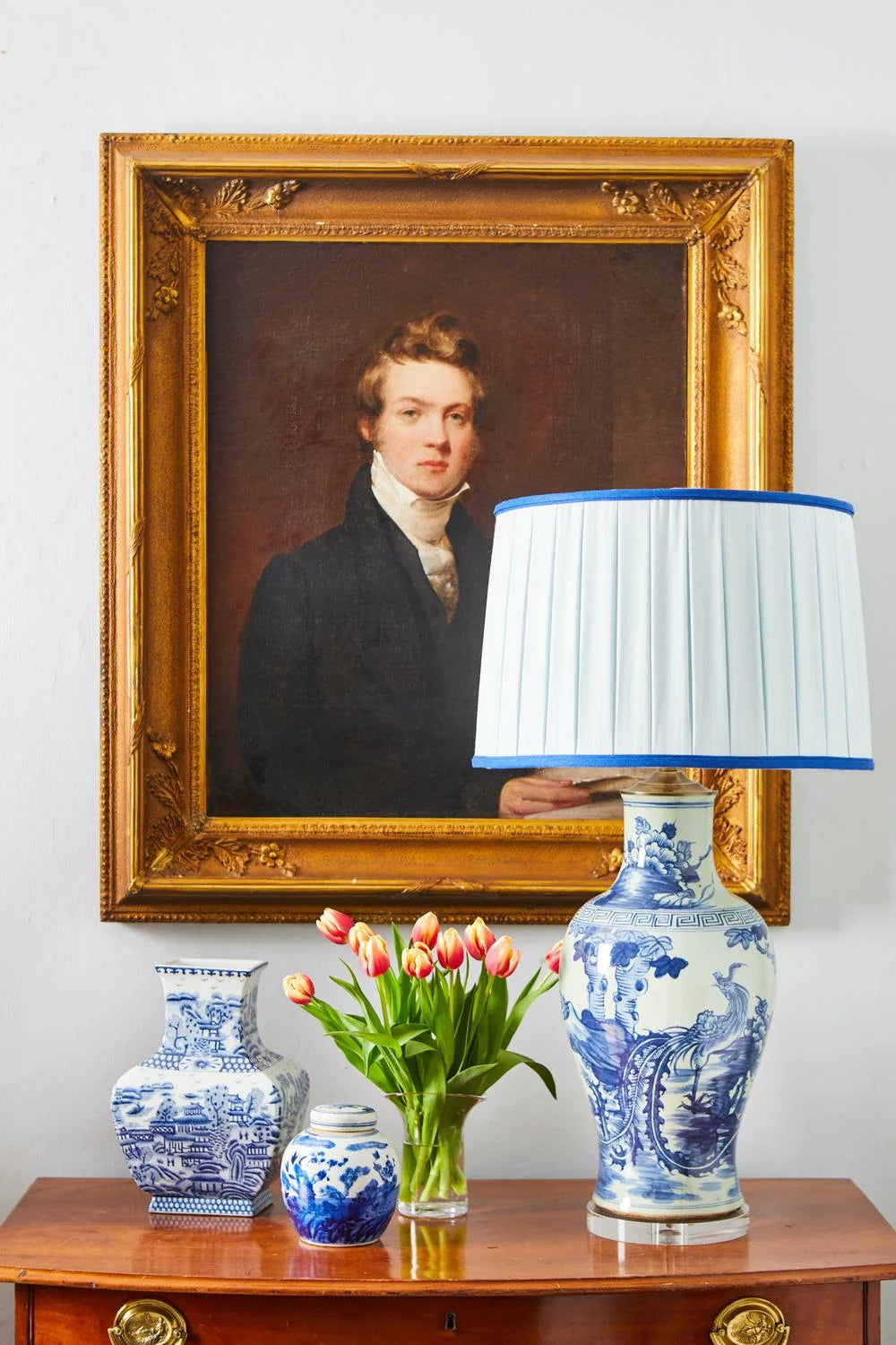 Sorella Glen Pale Blue Box Pleat Drum Lampshade with Bold Cobalt Trim styled on a white and blue ceramic table lamp in Nashville, Tennessee