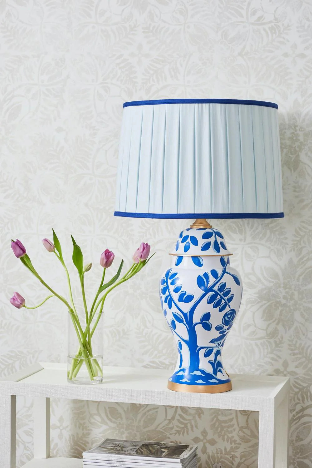 Sorella Glen Pale Blue Box Pleat Drum Lampshade with Bold Cobalt Trim styled on a white and blue ceramic table lamp in Nashville, Tennessee
