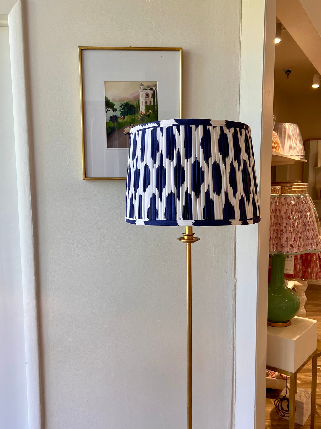 Sorella Glenn Navy Ikat Drum Lampshade styled on a brass floor lamp in Nashville, Tennessee