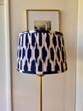 Sorella Glenn Navy Ikat Drum Lampshade styled on a brass floor lamp in Nashville, Tennessee