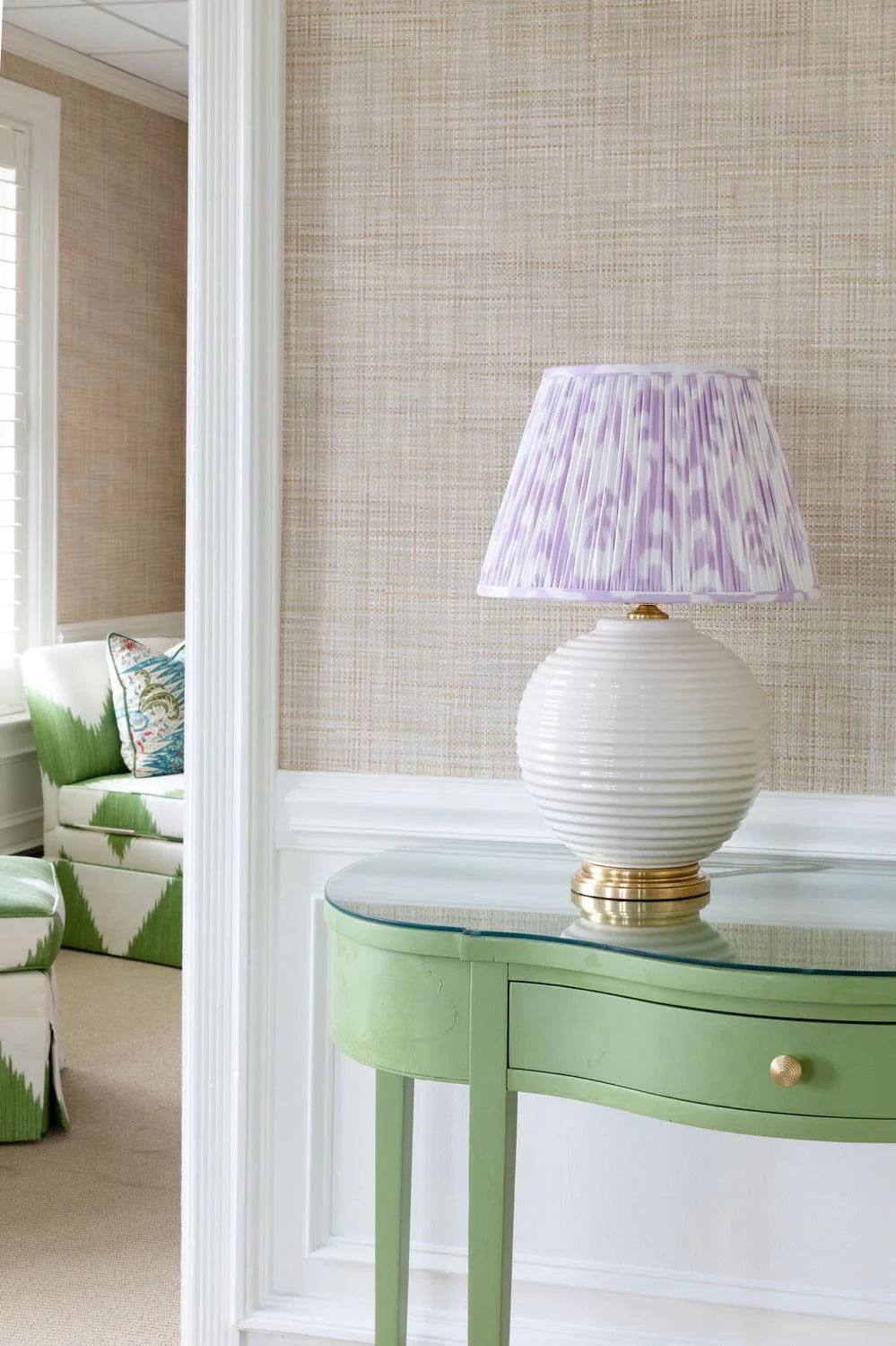 Sorella Glenn Soft Lavender Ikat empire lampshade on a white table lamp with gold base styled on a green console table
