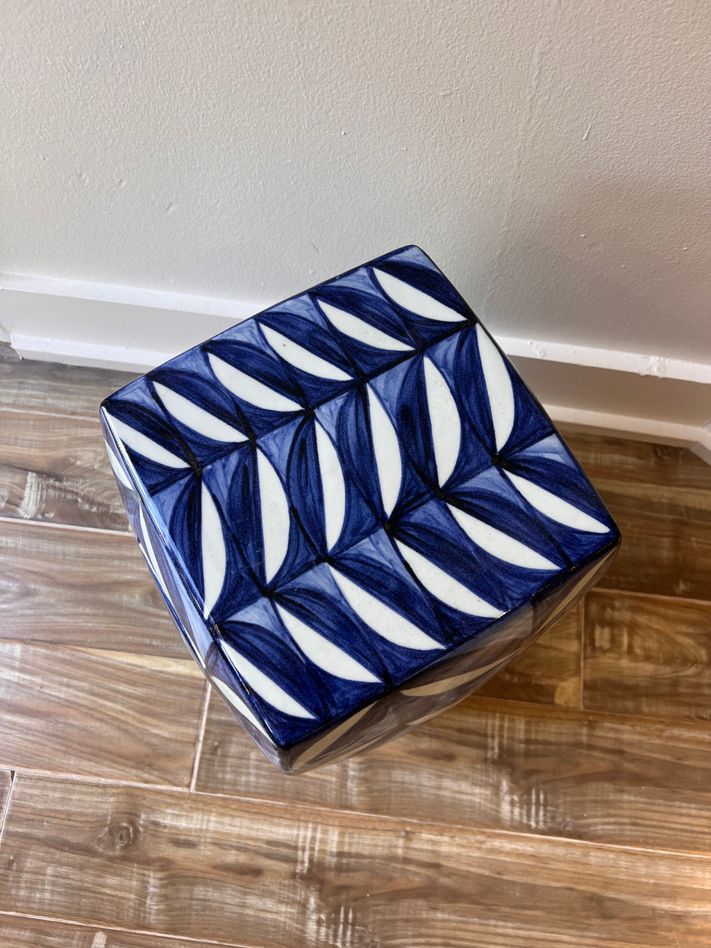Ceramic garden stool with blue leaf motif styled in Nashville, TN