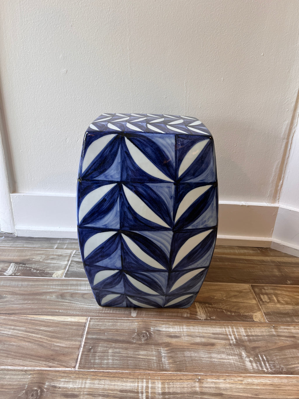 Ceramic garden stool with blue leaf motif styled in Nashville, TN