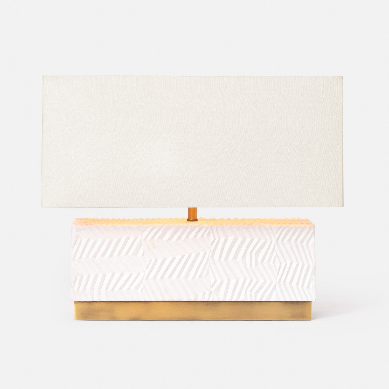 White rectangular table lamp with a contemporary, geometric design and brass base. Paired with a rectangular lampshade and available in Nashville, Tennessee