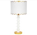 White table lamp with gold base and white scalloped lampshade
