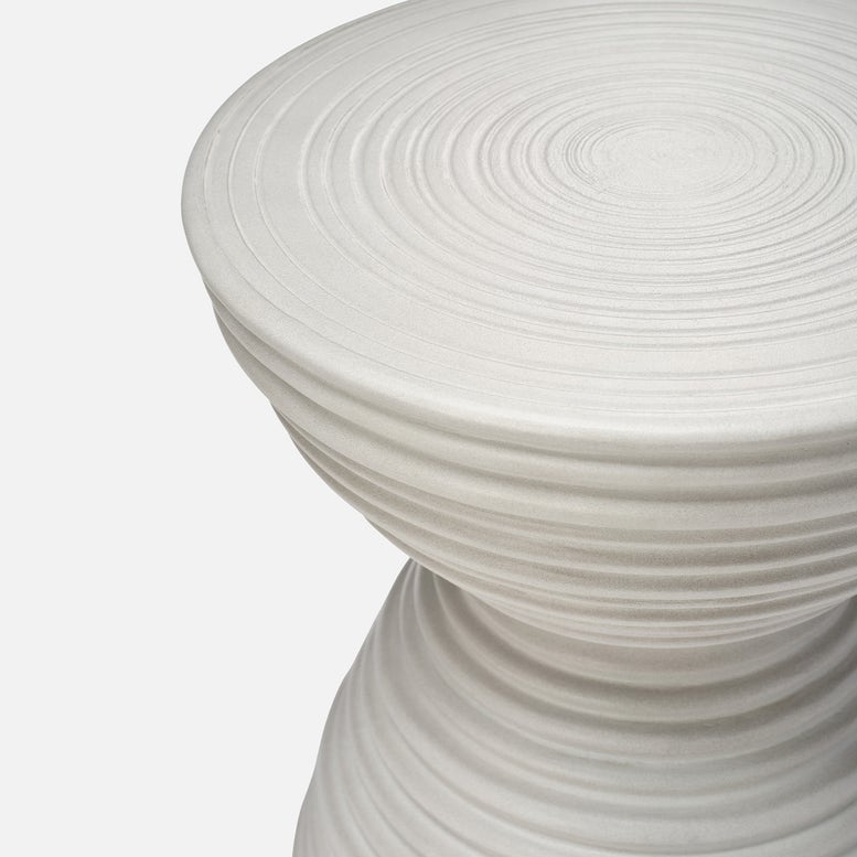 White sculptural garden stool with hourglass silhouette
