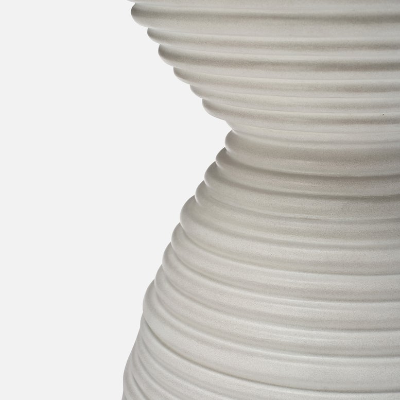 White sculptural garden stool with hourglass silhouette